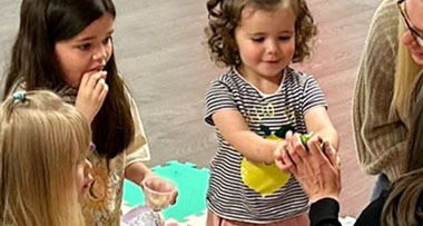 a group of children receiving food in a multi-sensory session