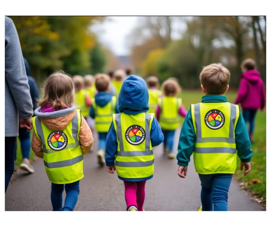 Class of nursery children out for a walk wearing high-visibility vests with the Sense-a-Story logo.